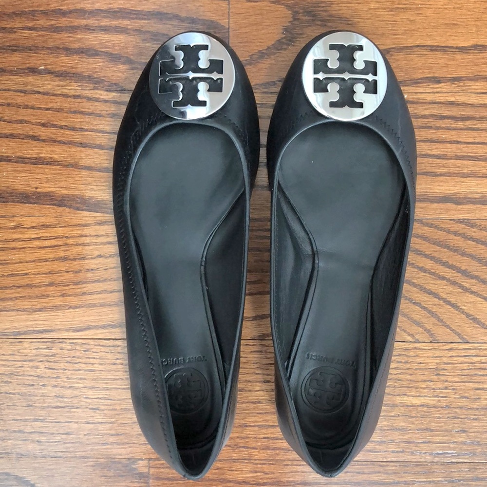 Tory Burch size 9.5 flats in black with silver medallion.
